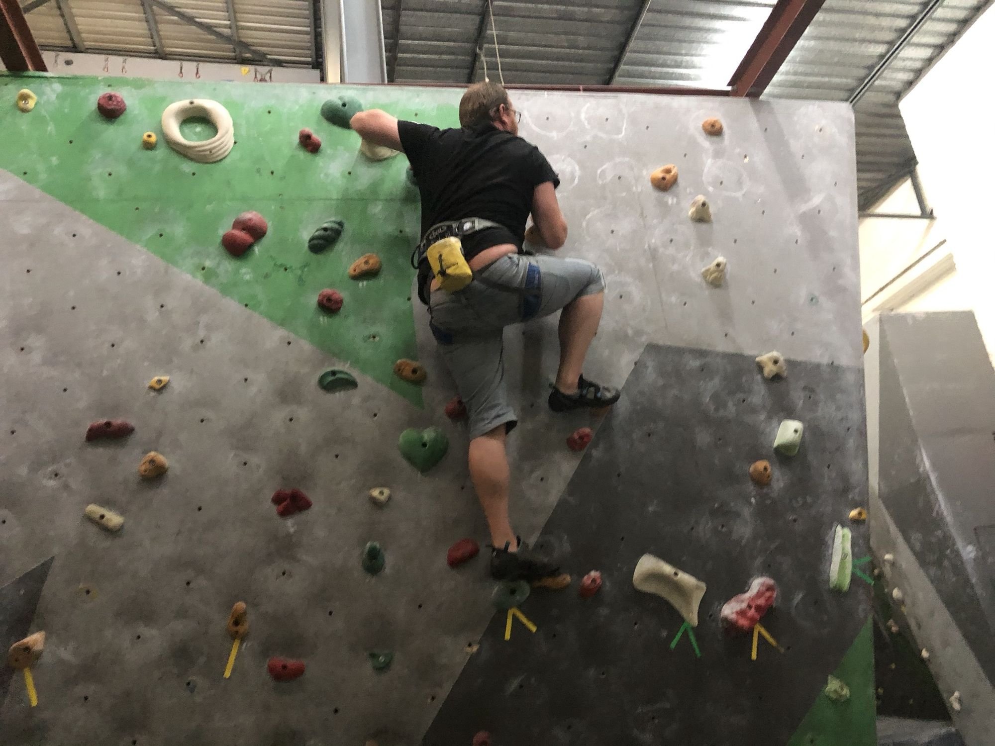 A climber on an indoor bouldering wall