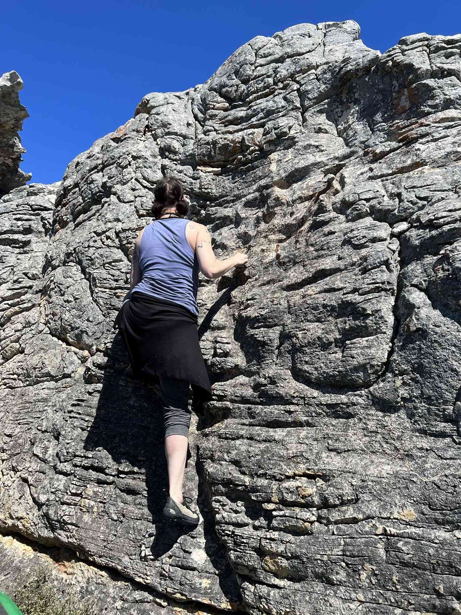 A climber on a granite boulder